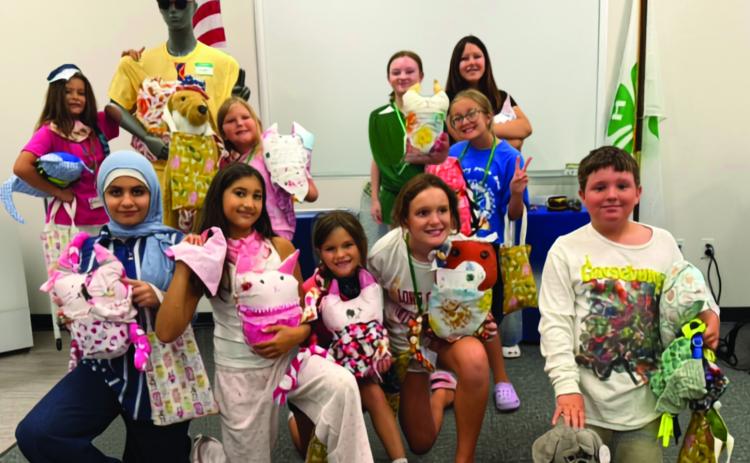 Campers pose with all of their completed projects next to the sewing mascot mannequin ‘Chad.’ (COURTESY UF/IFAS EXTENSION COLUMBIA COUNTY)