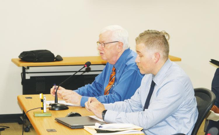Henry Thomas and Matthew Ori of Faftelis Financial Consultants walk North Florida Water Utilities Authority board members through a series of rate increases during Monday’s meeting. (TONY BRITT/Lake City Reporter)