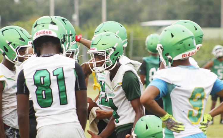 Suwannee receiver Kamari Lovett (center) demands better effort and results from his fellow teammates during 7-on-7 drills Monday. The Bulldogs’ offense had been dominated up until that point. (JAMIE WACHTER/Lake City Reporter)