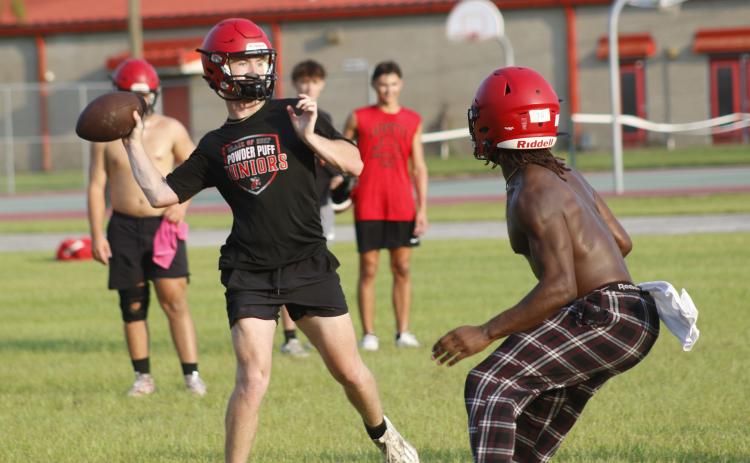 Lafayette quarterback Tucker Higginbotham throws a pass while being rushed by defensive end Zamarion Hawkins during Tuesday’s practice. (JAMIE WACHTER/Lake City Reporter)