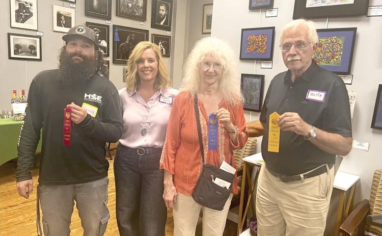 Taking the top prizes in the third annual Branford Camera Club Photography Exhibition and Competition were Georgia Schemetz (second from right), first place; Derek Linger (left), third place; and Rob Wolfe (right), honorable mention. Show coordinator Rachel Shelley is pictured with the winners. Not pictured are David Campione, who won second place, and Kathy Smith, who also captured an honorable mention. (COURTESY)