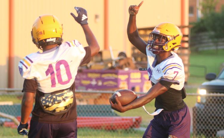 Columbia receiver Kyren Caldwell (right) celebrates with receiver Antonio Days after scoring a touchdown on a long catch-and-run during Monday’s practice. (JORDAN KROEGER/Lake City Reporter)