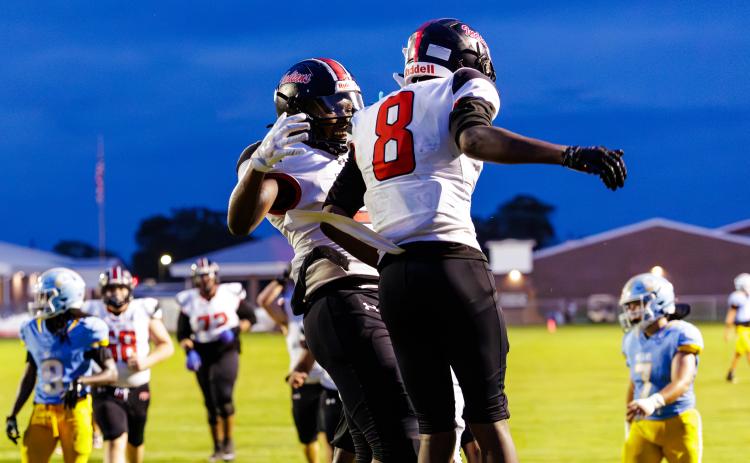 Fort White receiver Jakori Johnson (8) celebrates with receiver Brandon Robinson following a touchdown against Chiefland on Friday. (JACK HOWDESHELL/Lake City Reporter)