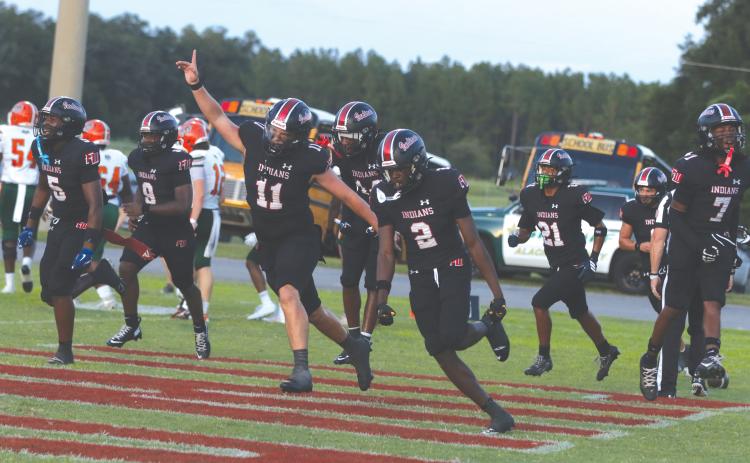 Fort White safety Marvion Wallace (2) celebrates with his teammates after his first interception return for a touchdown against Eastside on Friday. (MORGAN MCMULLEN/Lake City Reporter)