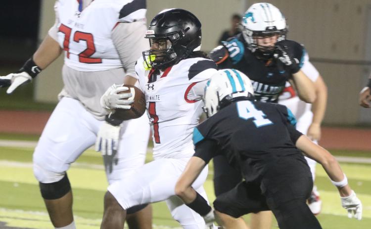 Fort White running back John'l Lawson runs by Providence defensive back Malachi Baughman on Friday night. (MORGAN MCMULLEN/Lake City Reporter)