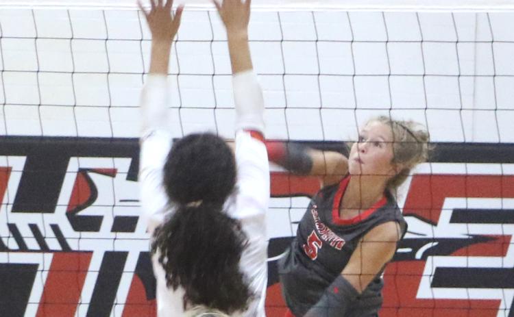 Lafayette outside hitter Havyn Richardson (5) fires a shot over the block of Fort White's Shaylee Lindsey during the Hornets' 3-1 win over the Indians. (MORGAN MCMULLEN/Lake City Reporter)