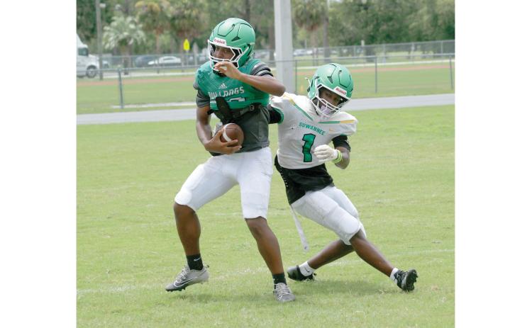 Suwannee safety Josh Johnson intercepts a pass in front of receiver Jamarcus Cherry during practice on Aug. 3. (JAMIE WACHTER/Lake City Reporter)