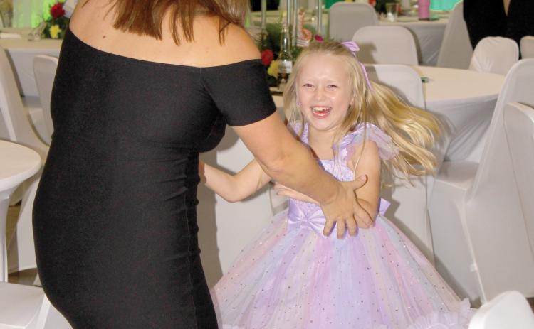 A child laughs while dancing at the inaugural Laced Up for Love Sneaker Ball last year. (COURTESY)