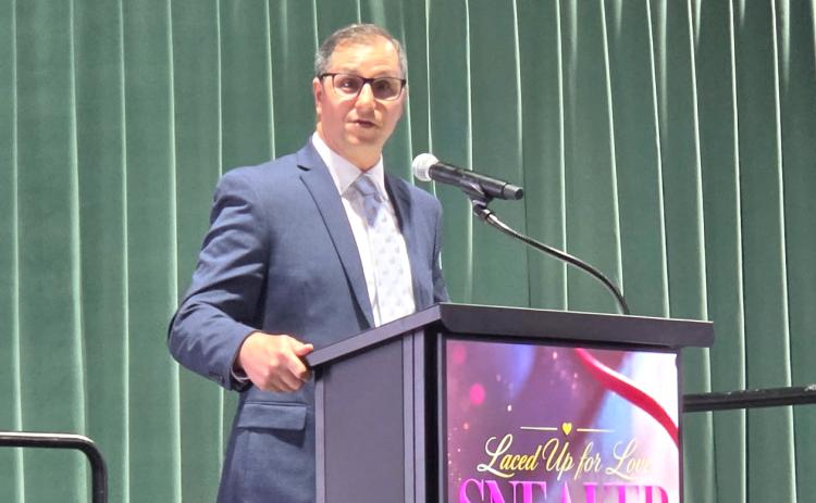 Lee Pinchouck, the director of the Foundation for Florida Gateway College, speaks at the Laced Up for Love Sneaker Ball on Saturday, which raised funds for Catholic Charities. (MONJA SLATER/Lake City Reporter)