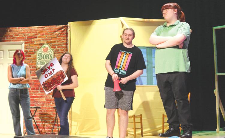 Clover Greene (from left), Chelsey Love, Logan Wright and Gavin Thomas participate in a scene where they discuss the town’s lone stop light in Fort White High School Theater’s upcoming production of ‘One Stoplight Town.’ (TONY BRITT/Lake City Reporter)