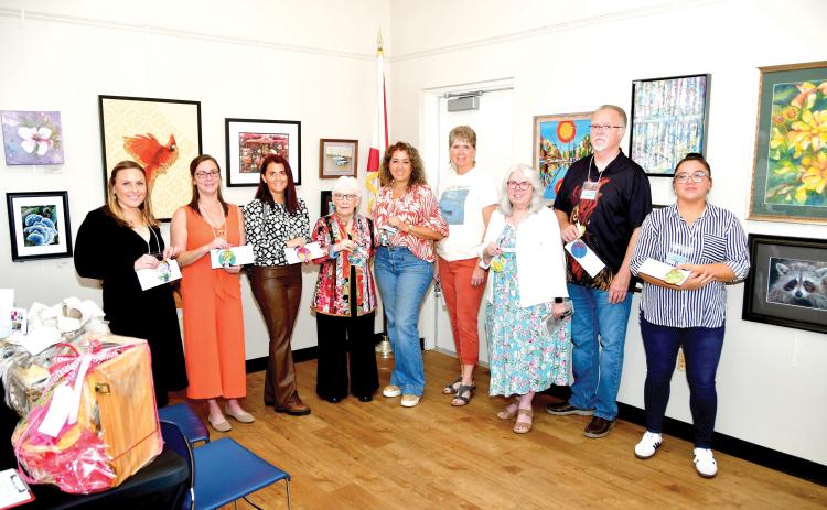 Winners in the Autum ArtFest, which is hosted by the Live Oak Artists Guild, Rachel Budwick (from left), April Phinazee, Jennifer Houston, Anda Chance, Mabel Gonzalez, Sharon Hester, Vaster Fryar, George Fryar and Mariena Craig. (ROB WOLFE/Lake City Reporter)