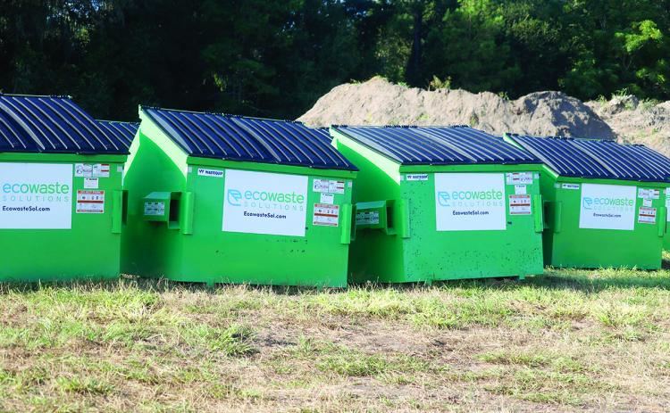 Ecowaste Solutions commercial dumpsters sit in Ellisville waiting to be swapped in for existing Waste Pro cans for customers around the county. Ecowaste takes over as the solid waste collection contractor on Oct. 1. (JAMIE WACHTER/Lake City Reporter)