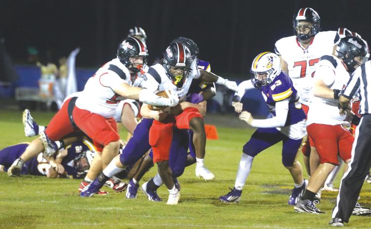 Fort White running back John’l Lawson tries to break free from a Union County defender during last Friday’s 33-0 win. (MORGAN MCMULLEN/Lake City Reporter)