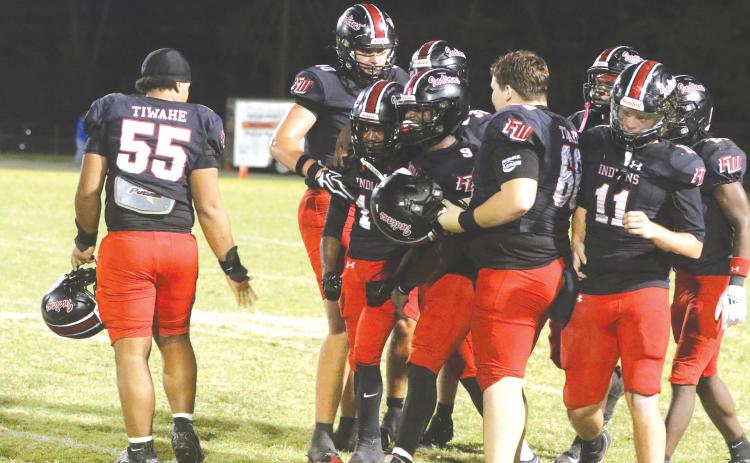 Fort White cornerback Jayton Walls is mobbed by teammates after his interception Friday against Taylor County. (MORGAN MCMULLEN/Lake City Reporter)