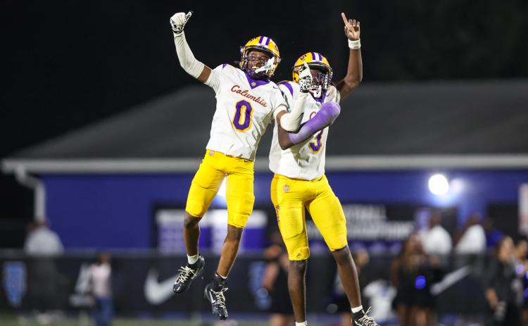 Columbia defensive back Mekah Combs-Turner (0) celebrates with defensive back Monterrence Williamson after one of his two turnovers against Trinity Christian on Friday. (GARY LLOYD MCCULLOUGH/Special to the Reporter)