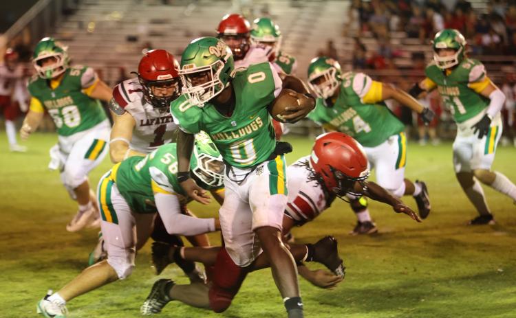 PAUL BUCHANAN/Lake City Reporter Suwannee running back Travon Fead gets around the corner of the Lafayette defense last Friday. (PAUL BUCHANAN/Lake City Reporter)