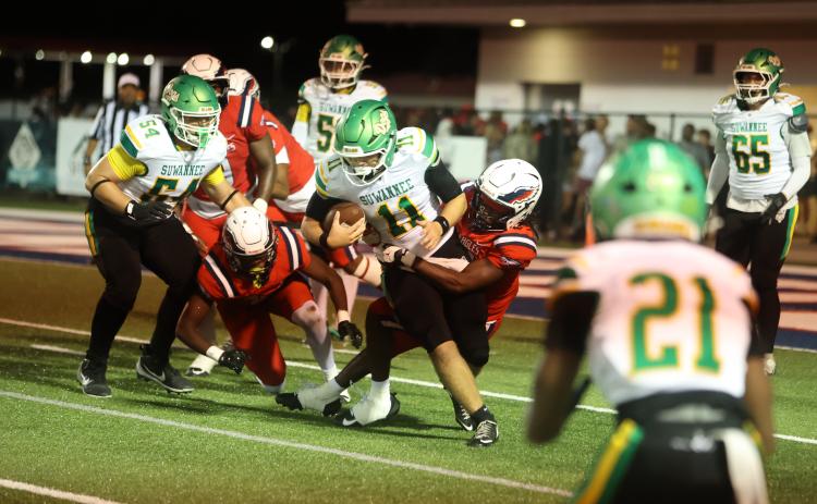 Suwannee quarterback Haigen Johnson is tackled by a Wakulla defender on Friday. (PAUL BUCHANAN/Lake City Reporter)