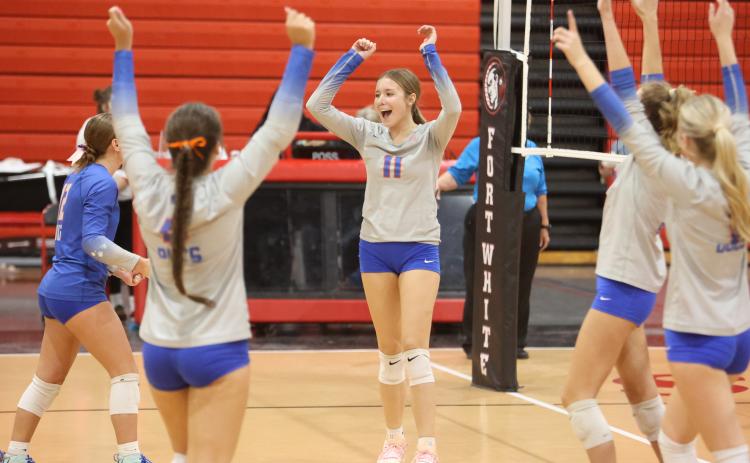 Branford hitter Paisley Knight (11) and the Buccaneers celebrate after a point against Fort White on Tuesday. (PAUL BUCHANAN/Lake City Reporter)