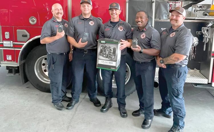 Lake City firefighters Chris Bethea (from left), Jayden Britton-Drew, Hunter Anderson, Mae Williams and Earl Lupardus, show the new gas monitors that were recently purchased by the fire department with grant funds. (COURTESY)