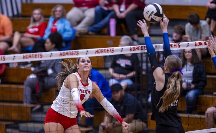 Lafayette middle hitter Sophia Kendrick sends a shot over the net against Branford on Aug. 27. (JACK HOWDESHELL/Lake City Reporter)