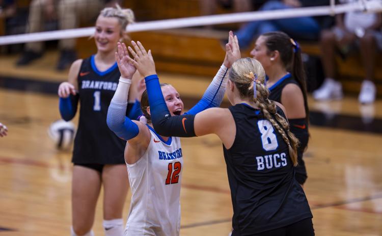 Branford libero Ava Alcorn (12) high fives hitter Anabella Dicks (8) during a win over Lafayette on Aug. 27.