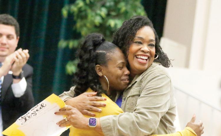 Minnie J. Niblack Elementary Principal Makeba Murphy (right) hugs Saporia Church on Tuesday morning after Murphy and the Columbia County School Board honored Church, a paraprofessional at the school, for saving a student’s life last month. (JAMIE WACHTER/Lake City Reporter)