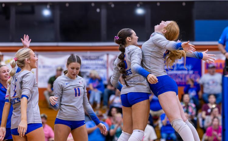 Branford's Adrianna Malaguti (5) celebrates her service ace with Calyssa Dicks (20) during Tuesday's win over Lafayette. (JACK HOWDESHELL/Lake City Reporter)