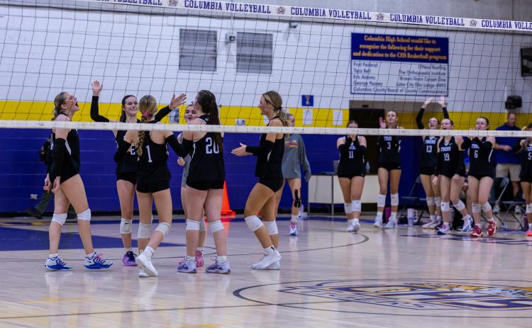 Columbia celebrates winning a set against Baker County on Oct. 8. (JACK HOWDESHELL/Lake City Reporter)