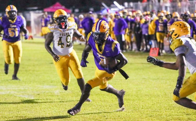 Columbia receiver Kyren Caldwell splits the Yulee defense for one of his three touchdowns Friday night. (BRENT KUYKENDALL/Lake City Reporter)