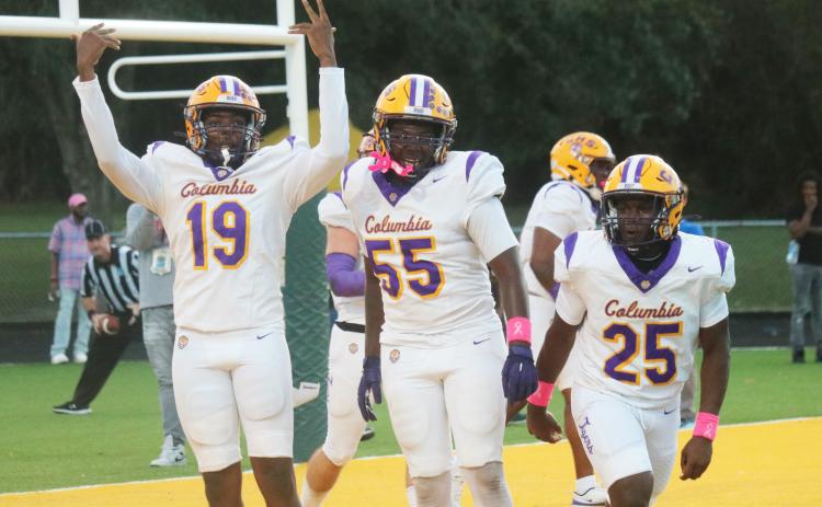 Columbia receiver Legend Camiel (19) celebrates one of his two touchdowns alongside offensive lineman Jiaun Wilson (55) and running back Jerome Horne (25) during last Friday’s win over Ed White. (JORDAN KROEGER/Lake City Reporter)