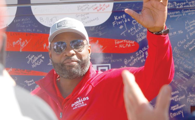Republican gubernatorial candidate Byron Donalds waves to a crowd in Live Oak on a bus tour stop Tuesday at the Elks Lodge in downtown Live Oak. (JAMIE WACHTER/Lake City Reporter)