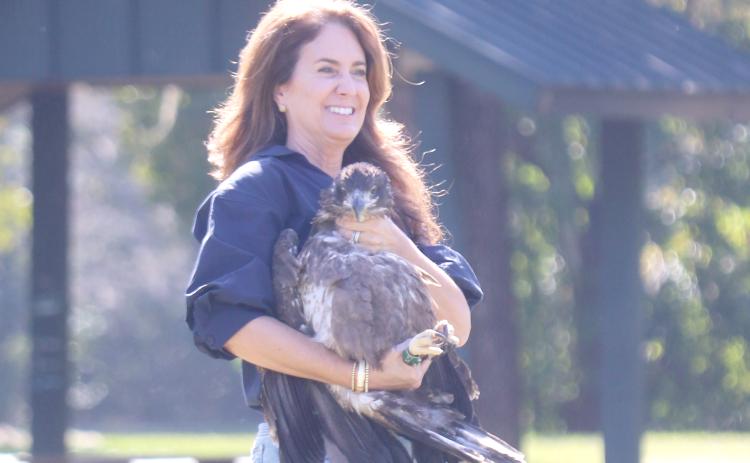 State Sen. Jennifer Bradley flashes a smile as she prepares to release a juvenile eagle that was rescued and rehabilitated into the wild near Alligator Lake on Wednesday afternoon. (TONY BRITT/Lake City Reporter)
