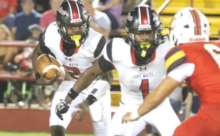 Fort White’s Marvion Wallace follows running back John’l Lawson on the wildcat run in last week’s 34-32 loss to Baker County. (MORGAN MCMULLEN/Lake City Reporter)