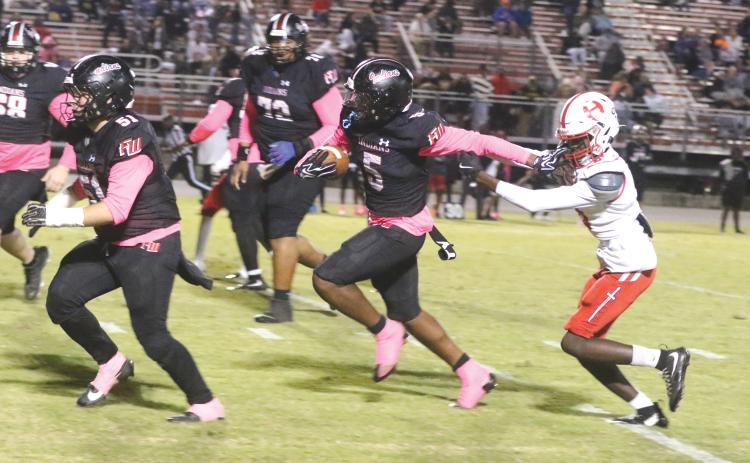 Fort White receiver Brandon Robinson stiff-arms Hamilton County defensive back Avrin Johnson on his way to a 35-yard touchdown in Friday’s 41-0 win. (MORGAN MCMULLEN/Lake City Reporter)
