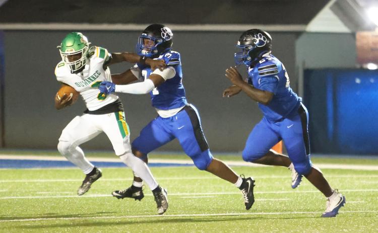 Suwannee running back Travon Fead can’t find any running room as he’s tackled by Godby safety Jayse Doss on Friday night. (PAUL BUCHANAN/Lake City Reporter)