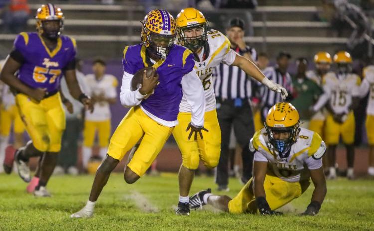 Columbia quarterback Amari Green scrambles through the Yulee defense for a gain during last Friday’s 42-0 win. (BRENT KUYKENDALL/Lake City Reporter)