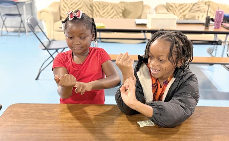Two students at Minnie J. Niblack Elementary School practice locating their pulse on their wrists during a 4-H Choose to Move lesson. Through hands-on discovery, students learned how their hearts respond to physical activity and why keeping their hearts healthy is an important part of taking charge of their health. (COURTESY COLUMBIA COUNTY EXTENSION)