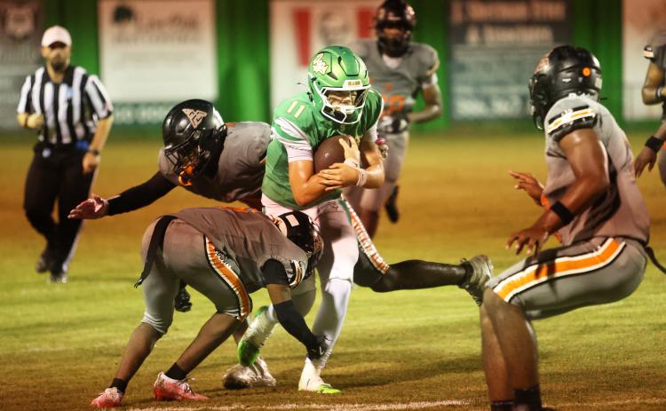Suwannee quarterback Haigen Johnson braces for a hit from Zarephath Academy last Friday. (PAUL BUCHANAN/Lake City Reporter)
