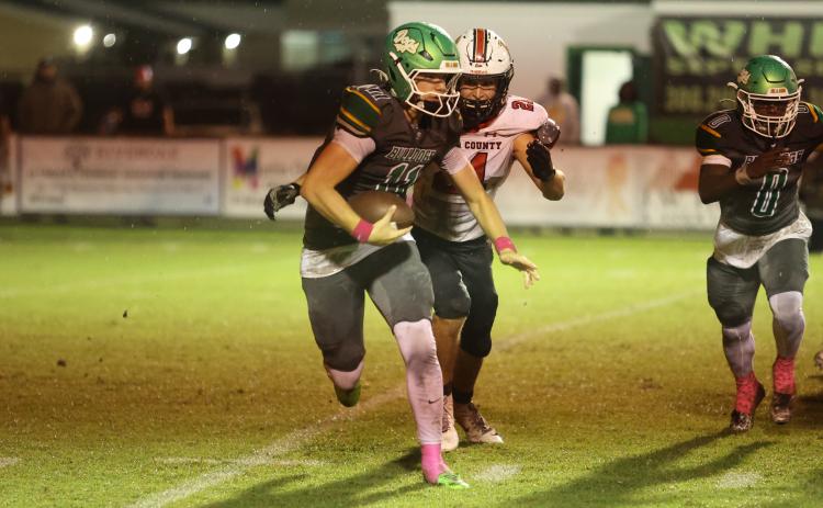Suwannee quarterback Haigen Johnson tries to scramble away from Baker County defensive end Joshua Chick on Friday night. Chick sacked Johnson on the play. (PAUL BUCHANAN/Lake City Reporter)