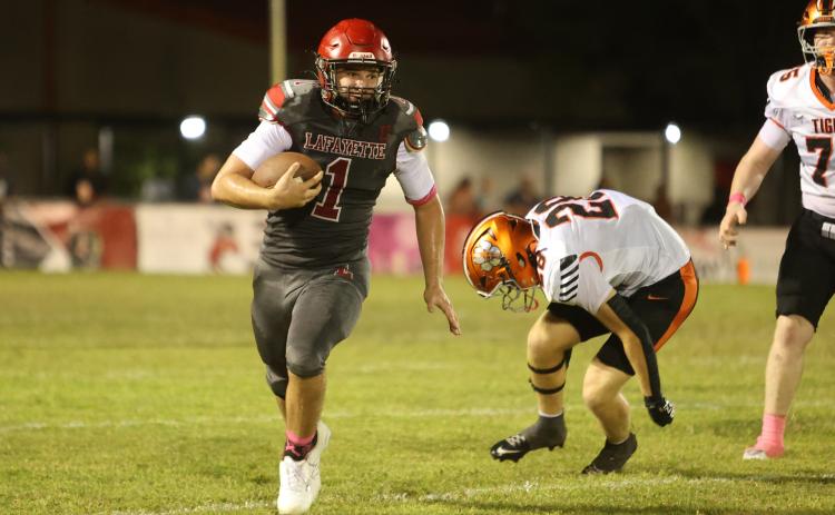 Lafayette quarterback Trevor Byrd turns the corner of the Trenton of the defense for a gain last Friday. (PAUL BUCHANAN/Lake City Reporter)