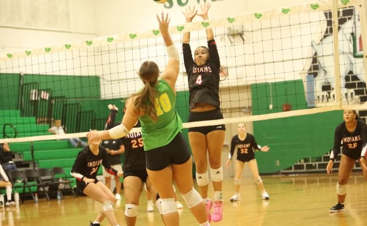 Fort White hitter Arianna Breeden (4) attempts to block a shot from Suwannee hitter Calinn Daniel on Aug. 25. (PAUL BUCHANAN/Lake City Reporter)