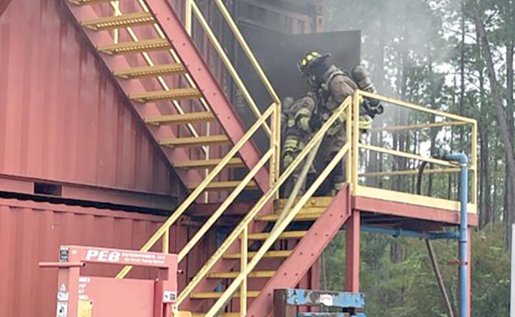 Lake City firefighters enter the burning building simulation at Florida Gateway College’s Public Safety Training Campus in Olustee. The firefighters were conducting one of their two training sesions at Olustee on Tuesday. (COURTESY LAKE CITY FIRE DEPARTMENT)