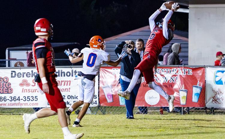 Lafayette receiver Coy Plunkett makes a leaping catch in the back of the end zone for a touchdown in front of Branford defender Colby Beard on Friday. (JACK HOWDESHELL/Lake City Reporter)