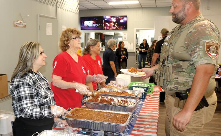 Agriculture Law Enforcement officer Zack Skinner gets a plate of barbecue from American Legion Post 57 volunteers during the post’s First Responder Luncheon on Wednesday. (TONY BRITT/Lake City Reporter)