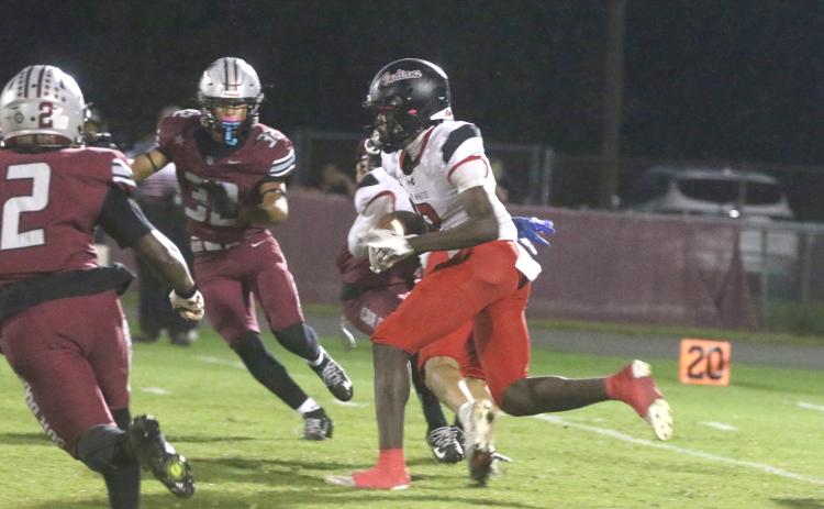 Fort White's Marvion Wallace takes the opening kickoff back 75 yards for a touchdown in the Indians' 42-26 loss to Madison County on Thursday. (MORGAN MCMULLEN/Lake City Reporter)