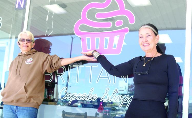 Inga Dwyer, the Toys for Tots coordinator for Columbia and Lafayette counties (left) and Sharon Ortiz, the owner of SB Clothing, stand outside Brittany’s Cupcake Shoppe ahead of the inaugural Reindeer Drop Toys for Tots fundraiser at the shop on Friday. (TONY BRITT/Lake City Reporter)