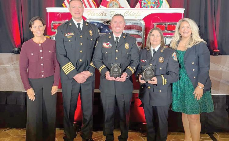 Suwannee County Fire Rescue Lt. Mica Taylor (second from right) and Capt. Chip Leathlean (center) were awarded the Florida Fire Chiefs Assocation’s Safety, Health, and Wellness Award of Excellence last week for their role in establishing the SCFR’s Peer Support Team to provide mental and emotional health support to fellow first responders. (COURTESY)