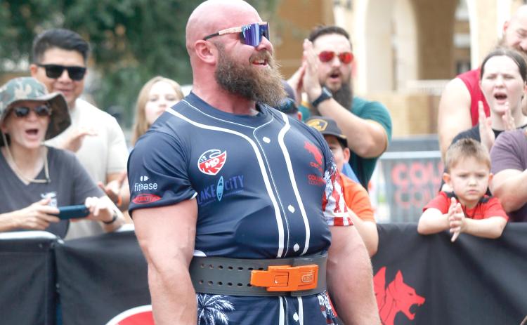 Strongman Tristain Hoath flashes a smile to the crowd as he deadlifts more than 800 pounds for a sixth time in a minute Saturday at Olustee Park as part of the Strongman Champions League competition. (JAMIE WACHTER/Lake City Reporter)
