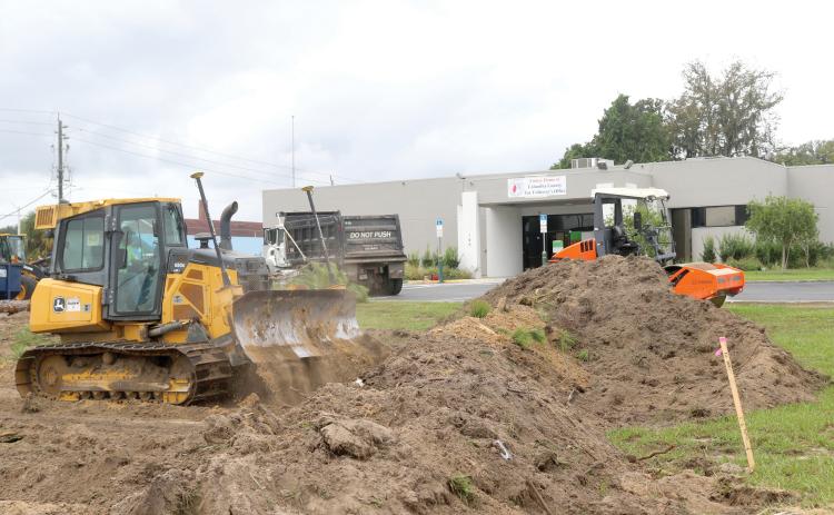 Crews have begun work on expanding the parking lot at the former TD Bank building on NW Main Boulevard for the new Columbia County Tax Collector’s Office. (TONY BRITT/Lake City Reporter)