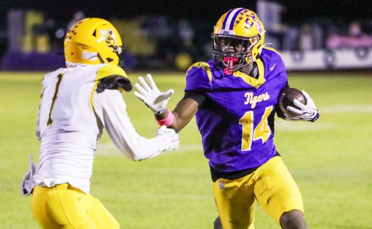 Columbia receiver Zion Walker stiff-arms Yulee defender Pete Kuhlman as he runs down the sideline after a catch on Friday. (BRENT KUYKENDALL/Lake City Reporter)